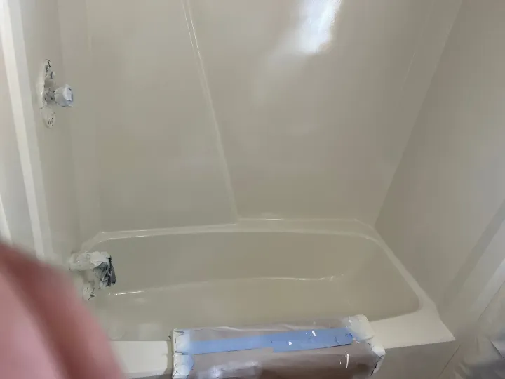 Blue bathtub and surround after reglazing with a clean white finish