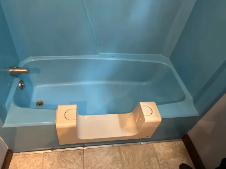 Blue bathtub and surround before reglazing