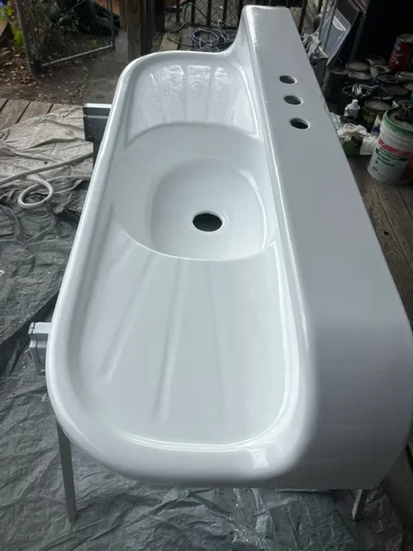 Vintage double drainboard farmhouse sink after refinishing with a glossy white finish