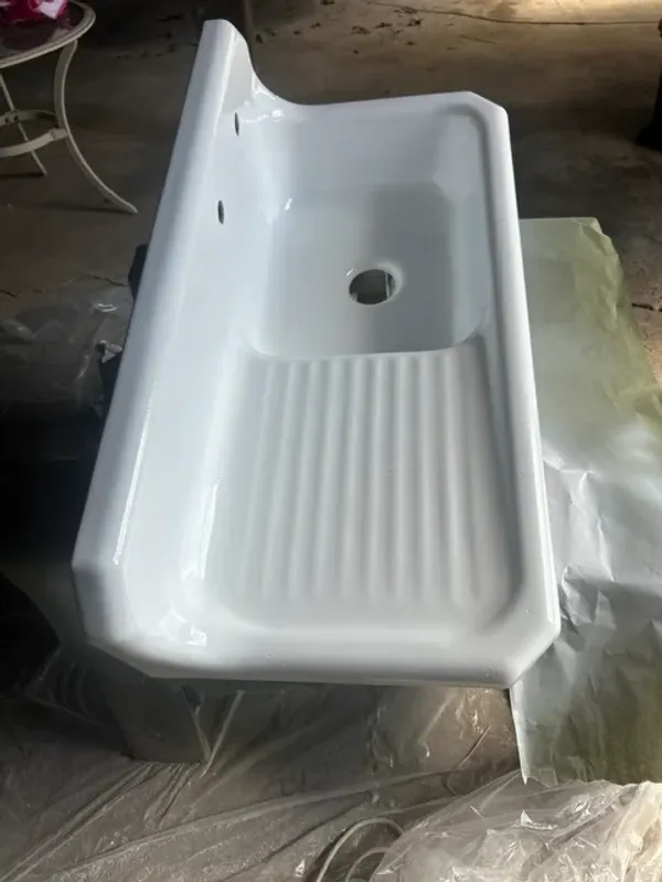 Vintage single drainboard sink after refinishing with a high-gloss white coating