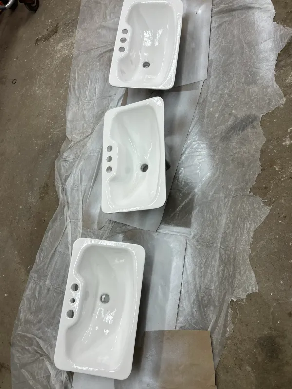 Multiple bathroom sinks after refinishing with glossy white finish