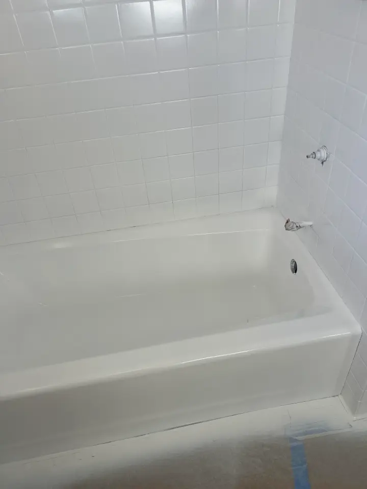 Bathtub and surround after reglazing with a clean glossy white finish