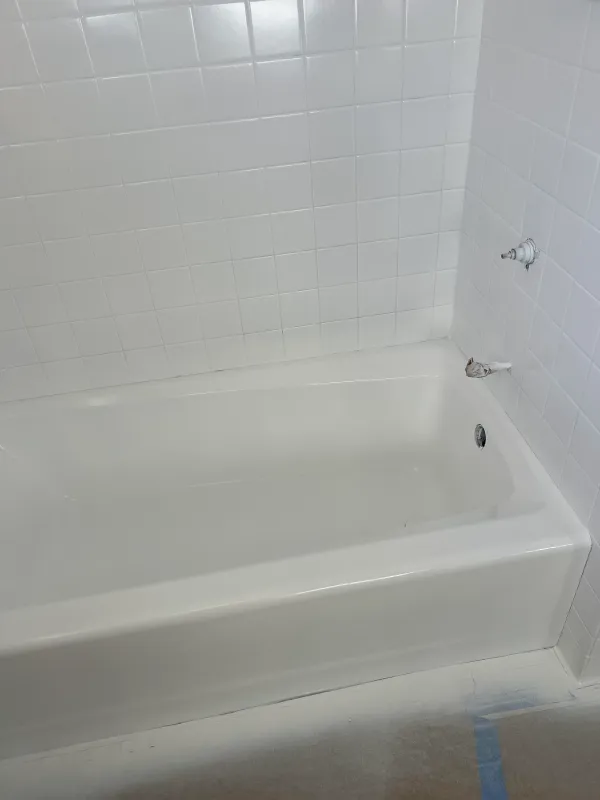 Bathtub and surround after reglazing with a clean glossy white finish